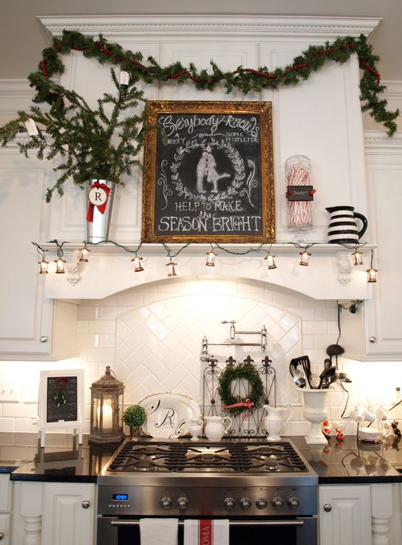 Colorful Christmas ornaments hanging from a kitchen stove hood