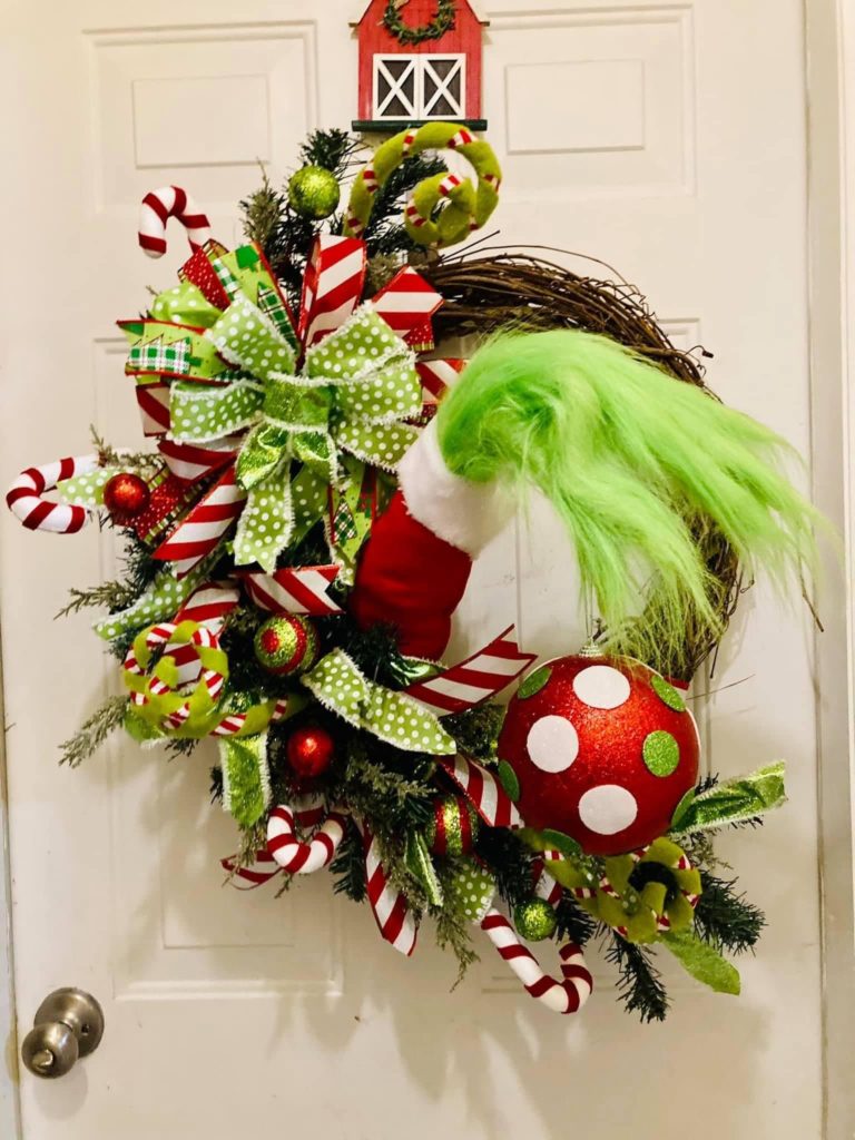 Personalized Grinch stockings knitted with green yarn and felt, filled with Who-hash cookies and candy canes