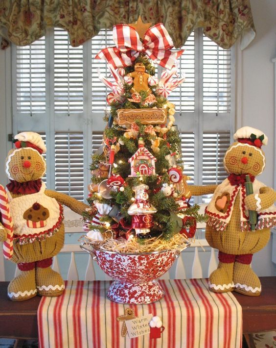 showstopping gingerbread centerpiece featuring intricate frosting designs, edible flowers like gingerbread roses and leaves, and colorful candy accents like candy canes and gumdrops.